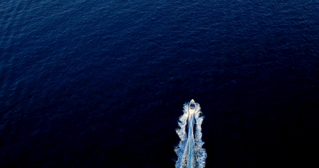 Boat at sea leaving a wake