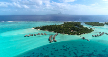 Water bungalows resort at islands, french polynesia in aerial view