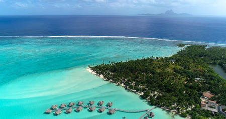 Water bungalows resort at islands, french polynesia in aerial view