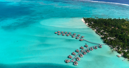 Water bungalows resort at islands, french polynesia in aerial view