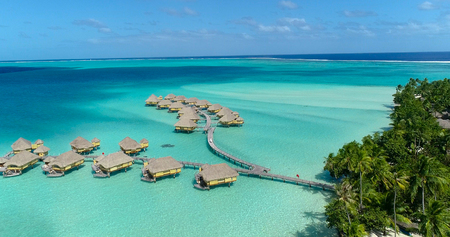 Water bungalows resort at islands, french polynesia in aerial view