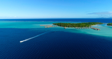 Water bungalows resort with islands, french polynesia in aerial view