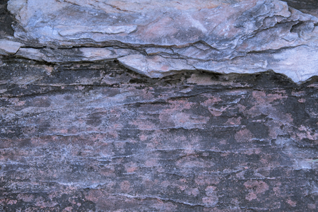 Big Rough stone with rugged crack surface. And there is moss on rock surface Occur naturally.の写真素材
