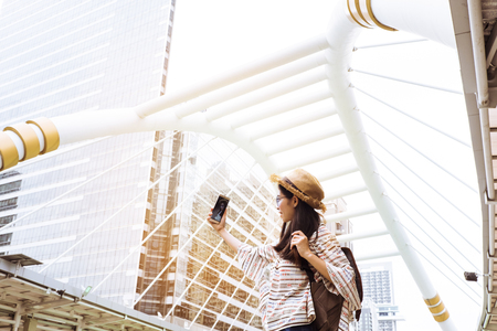 Asian women tourist Playing Smartphone To check out the attractions in Bangkok, Thailand. selfie and Upload photo to social.の写真素材