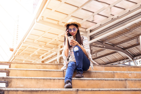 Asian women tourist Playing Smartphone To check out the attractions in Bangkok, Thailand. selfie and Upload photo to social.の写真素材