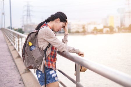 Asian female tourists backpack Asian female tourists are suffering from stress fatigue and unhappy During the trip On the roadside on holiday.の写真素材