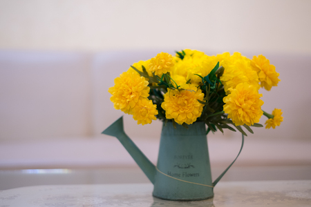 copyspace background and texture. artificial flowers marigold yellow decorated in beautiful vases placed on the table.の写真素材