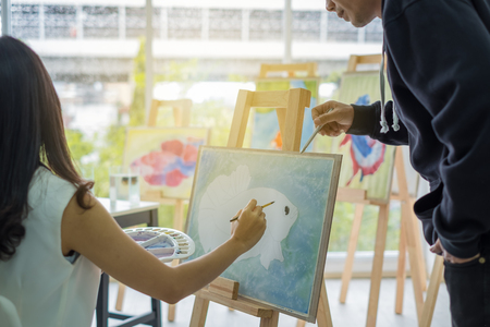 Art teachers teaching female students. and advice on how to create a beautiful art. With creativity and creativity.の写真素材