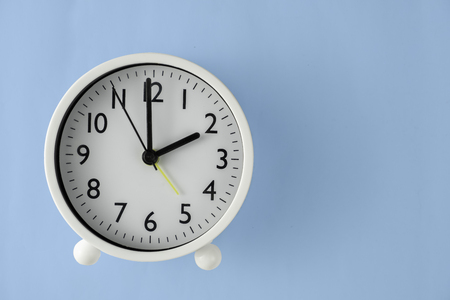 The clock is clockwise white at 14 o'clock Or 2 o'clock. Top view in blue background. clipping path.