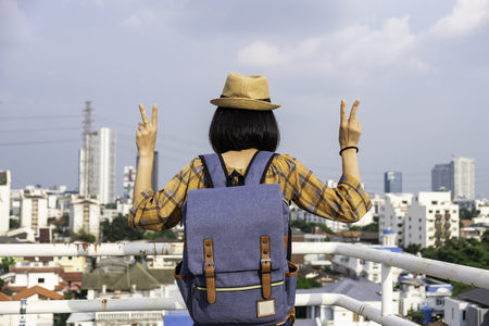Asian girl tourists Traveling backpackers stand to admire the beauty of the building. and landscape of Bangkok, Thailand. during his vacation trip.の写真素材