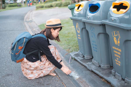 Asian female tourists While traveling He has collected garbage in public places. For the cleanliness of the place And have a good environment.の写真素材