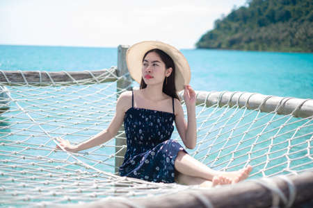 Asian woman tourists watching the sea view and admiring And the clear skies with beautiful clouds. Suitable for tourism, recreation and relax. at  Koh Kood Thailand.の写真素材