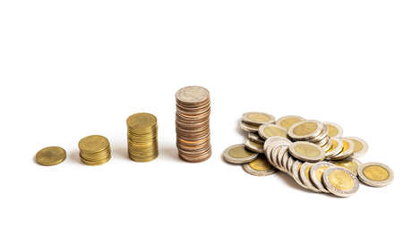 A collection of Thai  baht coins on a white backgroundの写真素材
