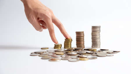 The hand is walking on the coins of thailand ladder It represents business and financial growth. on...