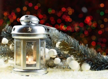 Christmas holidays background with candle lamp and bokeh.の写真素材
