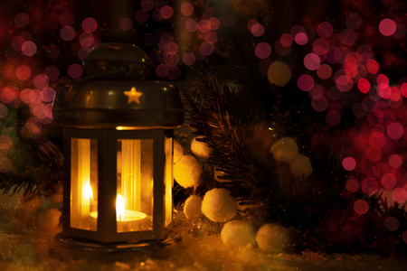 Christmas holidays background with candle lamp and bokeh.の写真素材