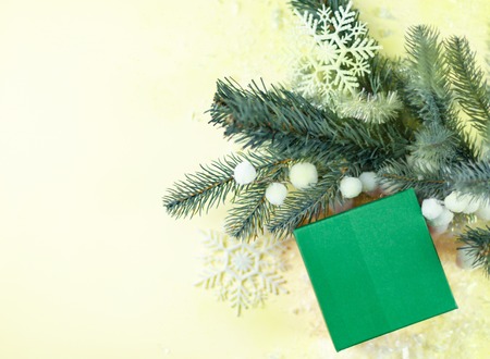 Holiday Christmas gift with copy space over Christmas tree background.の写真素材
