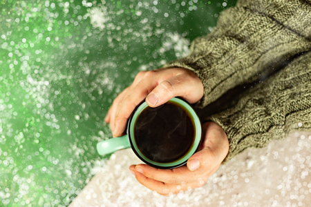 Holiday Christmas mug of tea or coffee in man hands with copy space.の写真素材