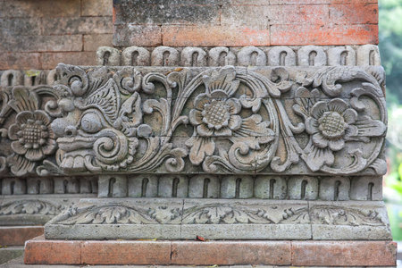 Brick wall with stone carving in Bali,Indonesia.の写真素材