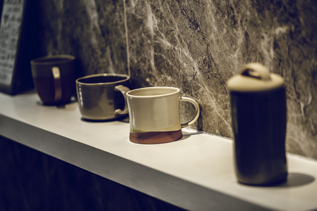 Coffee cup on  table white and wall marble background - Vintage effect style picturesの写真素材