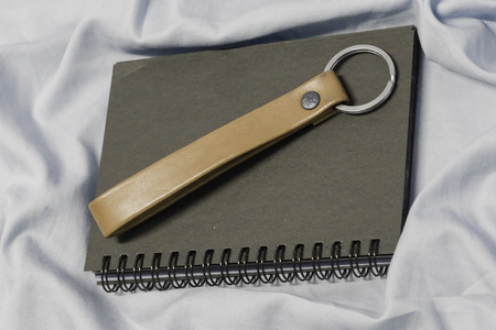 Vintage notebook cover with Leather key chain . Notebook on fabric. One notebook on fabric Indigo....