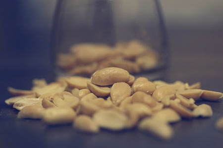 nuts beans in the glass bowl on wood tableの写真素材