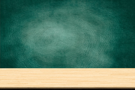 Abstract wooden table texture and chalk rubbed out on blackboard, for graphic add product, Education concept, Interior design display your product.の写真素材