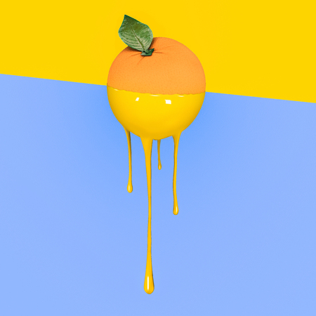 Grapefruit with dripping yellow paint on pastel blue and  yellow background. Minimal food concept.の写真素材