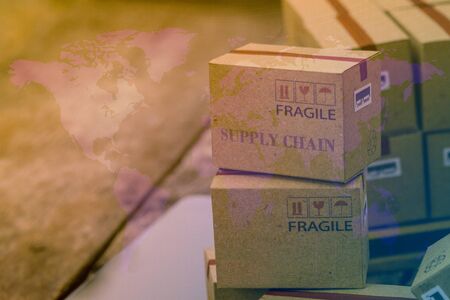 Packing light brown cardboard boxes with world map. An idea of transportation that can be done easily nowadays using an online internet at hand. Ready to ship worldwide. の写真素材