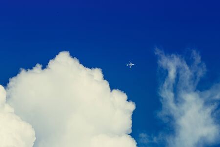 Blue sky and clouds with plane. Airplane flying in the blue sky among clouds and sunlight. picture background website or art work design. freedom with sky.の写真素材