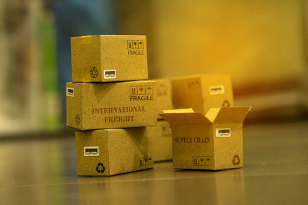 Pile of light brown small cardboard boxes. Concept of Shipping that can be done easily or purchase goods or services remotely. just using an online internet. transportation business conceptの写真素材