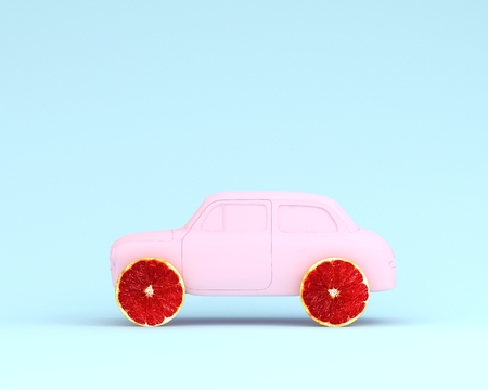Grapefruit layout wheel and car pink on pastel blue background. minimal idea food and fruit concept. Idea creative to produce work within an advertising marketing communications. Business conceptの写真素材