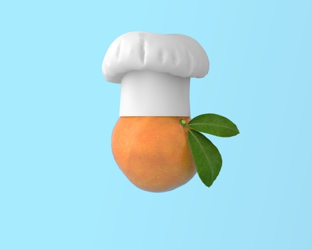 Chef hat with Orange fruit concept on pastel blue background. minimal idea food and fruit concept. Idea creative to produce work within an advertising marketing communications or artwork design.の写真素材