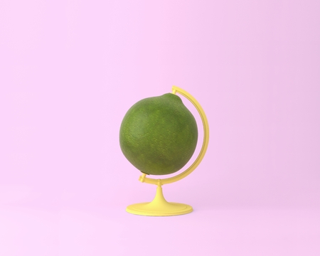 Globe sphere orb lemon, lime concepts on pastel pink background. minimal idea food and fruit concept. An idea creative to produce work within an advertising marketing communications. Business conceptsの写真素材