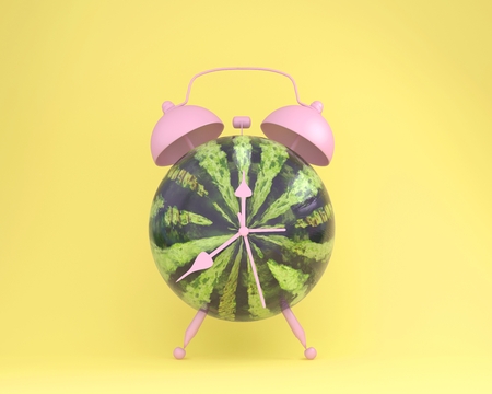 Creative idea layout fresh watermelon alarm clock on pastel yellow background. minimal idea business concept. fruit idea creative to produce work within an advertising marketing communicationsの写真素材