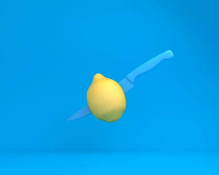 Creative layout made of knife blue in lemon on blue background. minimal idea food concept. An idea creative to produce work within an advertising marketing communications or artwork design.の写真素材