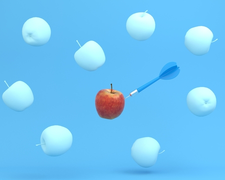 Outstanding blue dart in apple on blue color background. minimal idea food and fruit concept. An idea creative to produce work within an advertising marketing communications or artwork design.の写真素材
