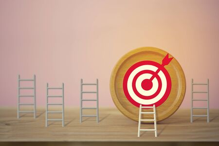 Goals concept: Longest white ladder and aiming high to goal target among other short ladders, depicts excellent performance and stands out from the crowd and thinks differently.の写真素材