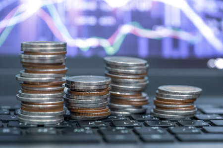 Concept finance/ Saving money for future growth.Financial stock market graph and rows of coins...
