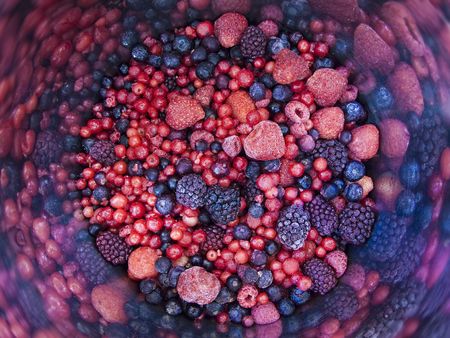 Bowl of mixed black and red berriesの写真素材