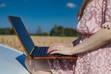 Girl working on laptop, hand close-upの写真素材