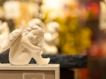 Angel sitting seat on the box porcelain figurine.の写真素材