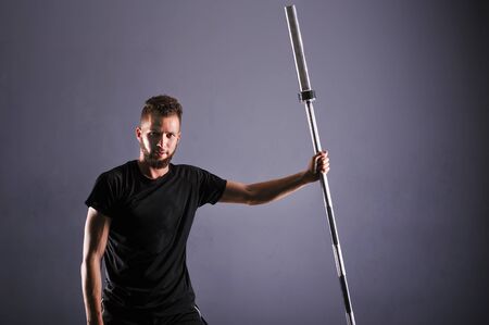 The man in the gym shows a thumb. The man after the training in the gym. Close up. Sports man. The strong big rolled man in the gym. Thumb upの写真素材