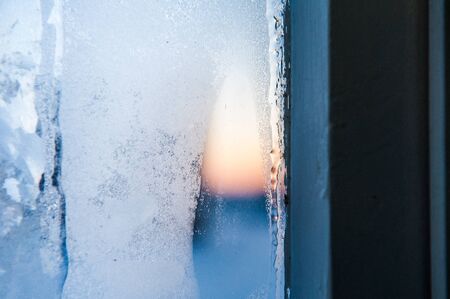 Window frame with Frost patterns on window. Festive bokeh backgroundwhite glass textureの写真素材