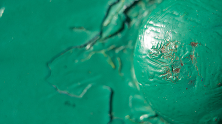 metal surface with old paint, some visible damage, as well as metal rivets and bolts connecting the sheets of material. Small depth of field.の写真素材