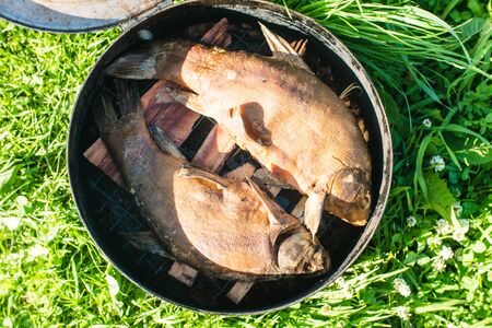 Fish Smoking Process For Home Use. Smoked fish. Close Up Smoking Process Fish In Smoking Shed For...