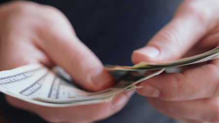 Businessman hands counting many american 20 dollars banknotes 4K close up slow moの写真素材