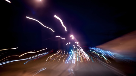 Fast car trip time lapse on the highway by night seen from the carの写真素材