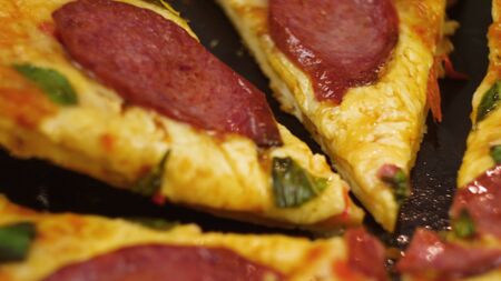 Human hands taking pieces slices of hot tasty italian pizza from open box, close up viewの写真素材