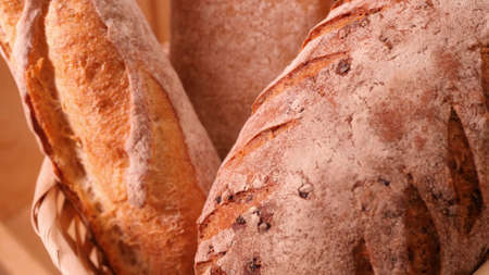 Breads and other bakery in decorative basket in background close up slow motion medium shot in 4Kの写真素材